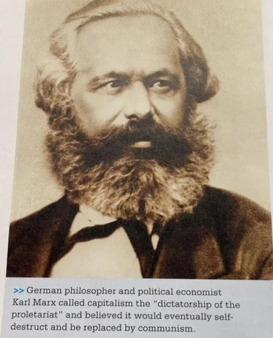 Picture of a text book depicting Karl Marx with the caption: "German philosopher and political economist Karl Marx called capitalism the 'dictatorship of the proletariat' and believed it would eventually selfdestruct and be replaced by communism."